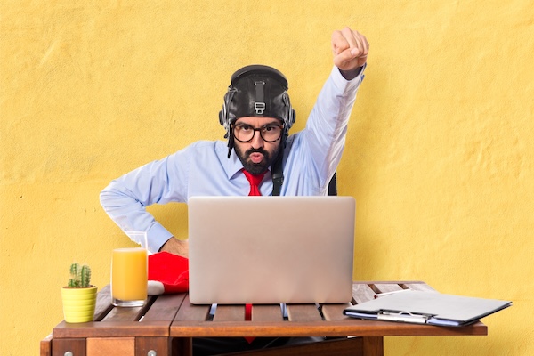 Businessman in his office with pilot hat